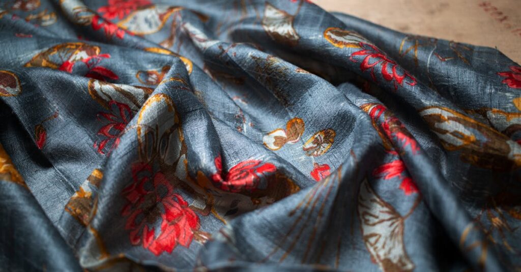 Close-up of elegant floral patterned fabric with rich colors, perfect for fashion and interior designs.